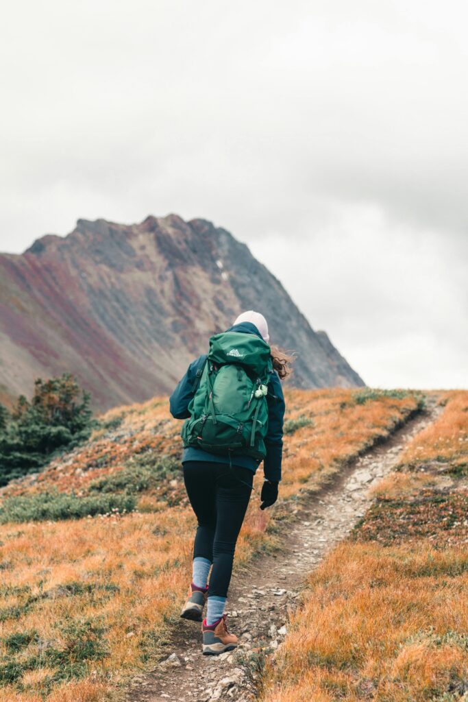 “A woman enjoying a solo walk in nature, embracing the slow living lifestyle.”