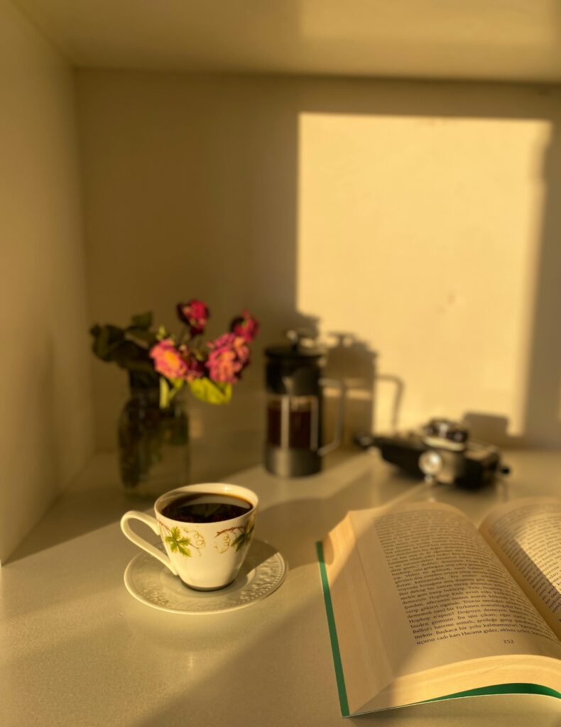 “A cozy tea table setup with sunlight, representing the calm essence of slow living.”